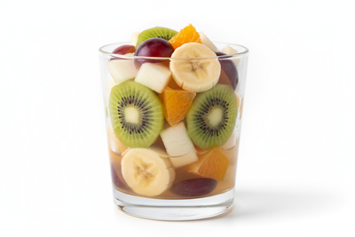 FRUIT SALAD, IN A LOW GLASS WITH VERY LIGHT BROWN LIQUID WITH APPLE, KIVI, GRAPE, NAJANRA AND BANANA